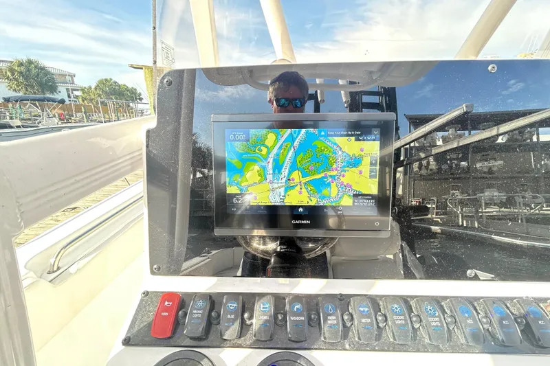 Slide: The Image of Control panel of 2025 Sea Hunt Ultra 229 boat with Garmin navigation display. - 19