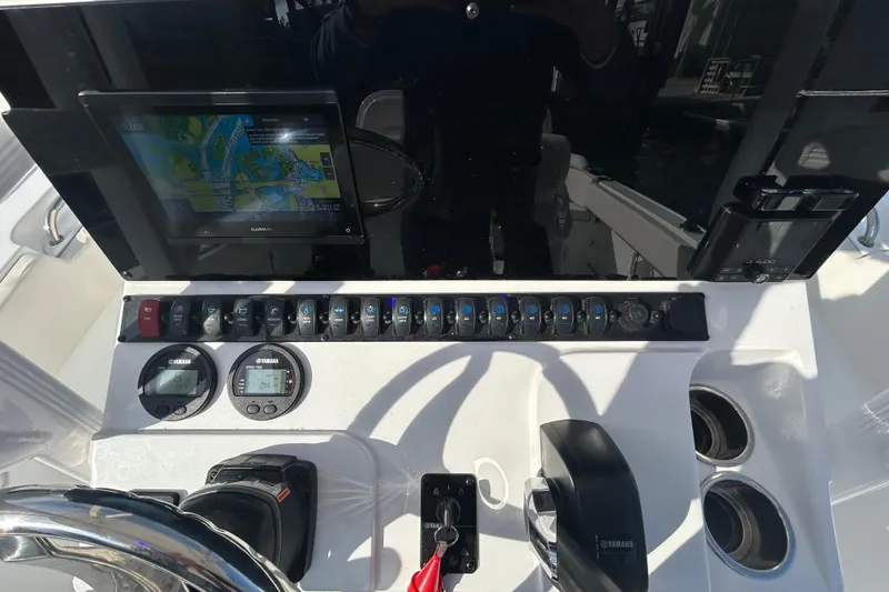 Slide: The Image of Dashboard of 2025 Sea Hunt Ultra 229 boat with navigation and control instruments. - 21