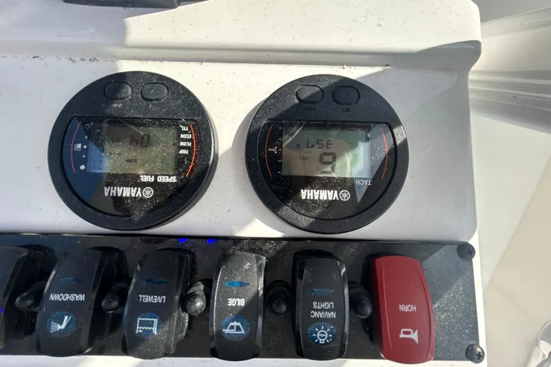 Slide: The Image of Yamaha gauges and switches on 2025 Sea Hunt Ultra 229 boat dashboard. - 22