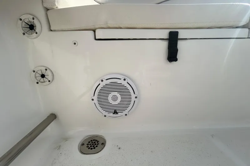 Slide: The Image of Interior of 2025 Sea Hunt Ultra 229 boat showing speaker and drainage system. - 24