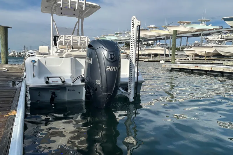 Slide: The Image of 2025 Sea Hunt Ultra 229 boat with Yamaha 200 engine docked at marina. - 27