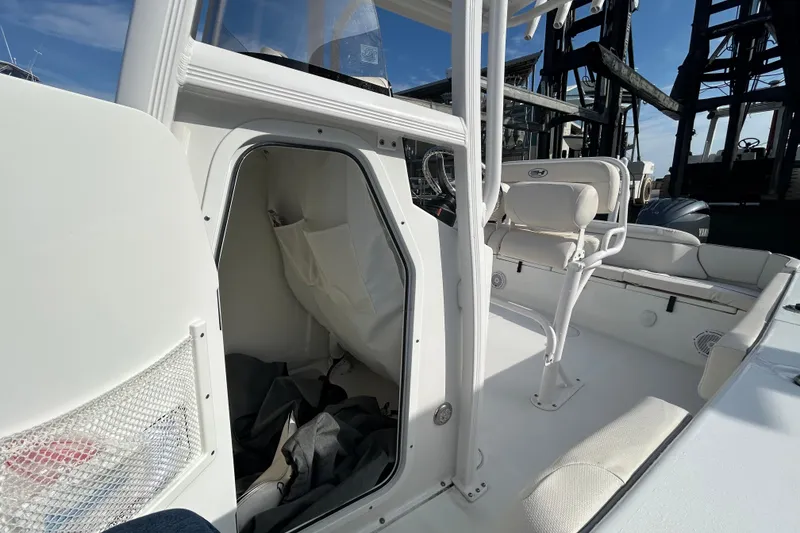 Slide: The Image of 2025 Sea Hunt Ultra 229 boat interior with seating and storage area. - 28
