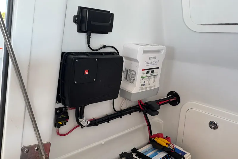 Slide: The Image of Electrical components inside a 2024 Yellowfin 36 Offshore boat, featuring wiring and control systems. - 23
