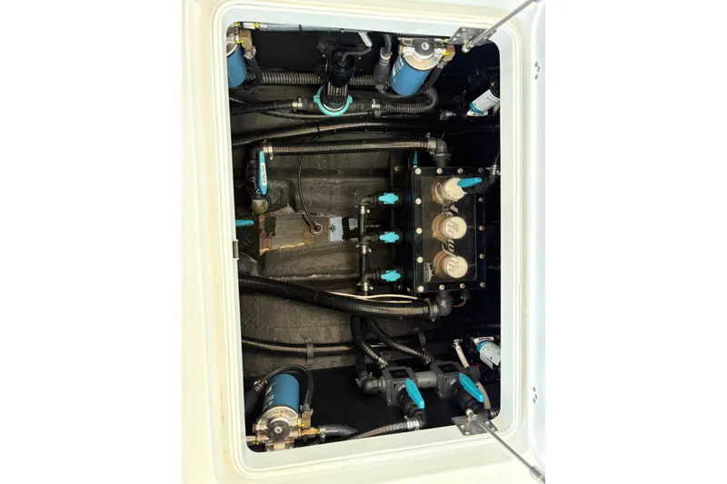 Slide: The Image of 2024 Yellowfin 36 Offshore boat engine compartment with complex wiring and components. - 26