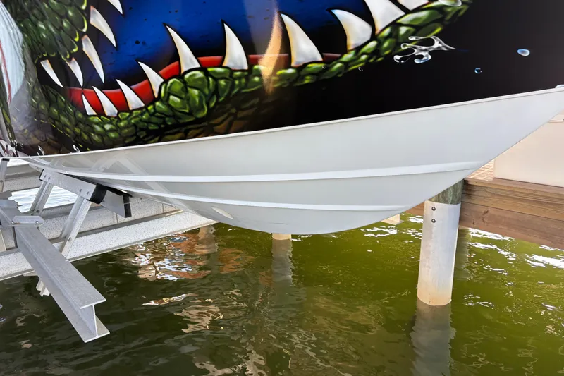 Slide: The Image of 2024 Yellowfin 36 Offshore boat with vibrant, artistic hull design on a lift. - 4