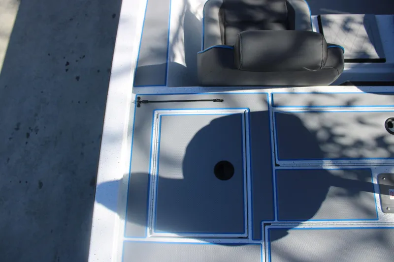 Slide: The Image of Deck of 2026 Xpress H20 boat with seating and storage compartments. - 16