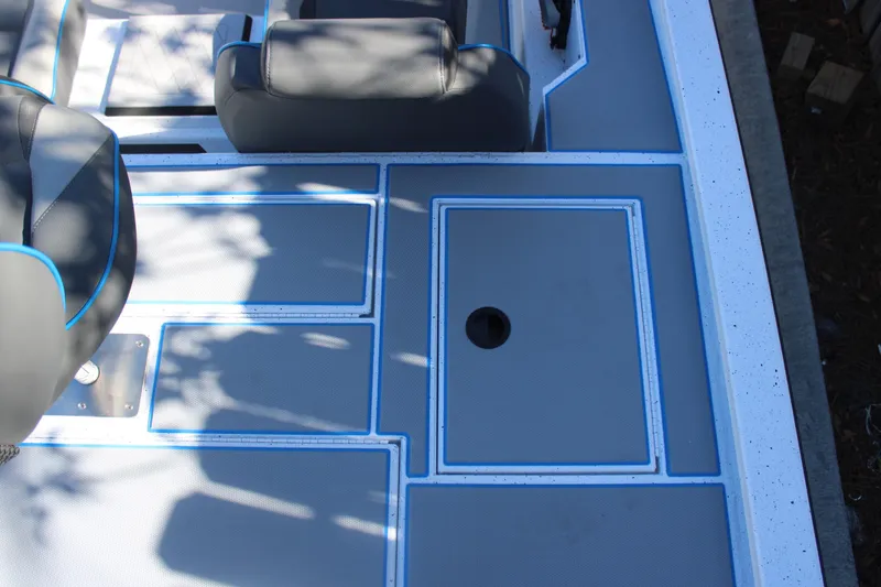 Slide: The Image of Xpress H20 2026 boat interior with gray and blue seating and deck design. - 18