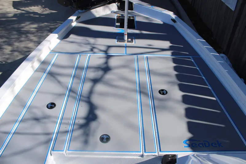 Slide: The Image of 2026 Xpress H20 boat deck with SeaDek padding and blue accents. - 21
