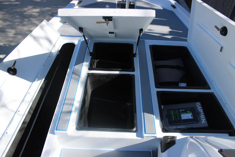 Slide: The Image of Open storage compartments on 2026 Xpress H20 boat deck, featuring Garmin equipment. - 22