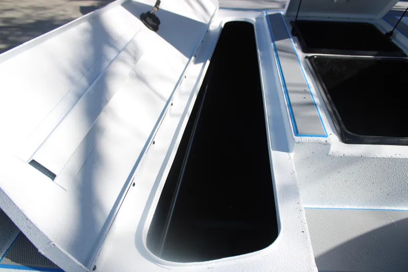 Slide: The Image of Open storage compartments on a 2026 Xpress H20 boat deck. - 23