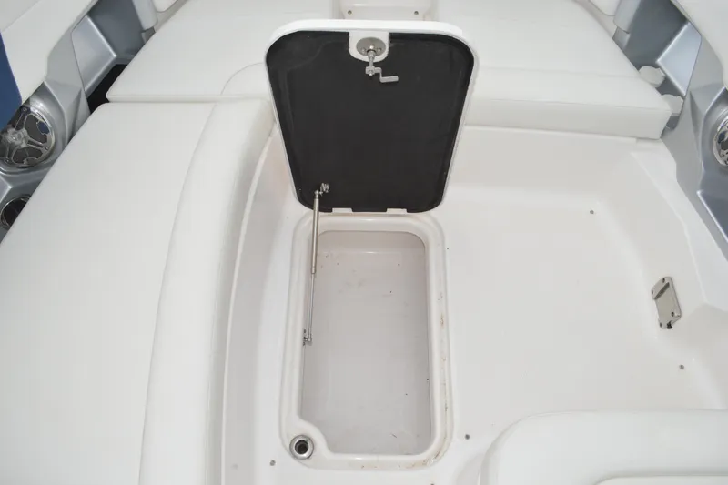 Slide: The Image of 2013 Chaparral 327 SSX boat storage compartment with open hatch, showcasing interior space. - 13
