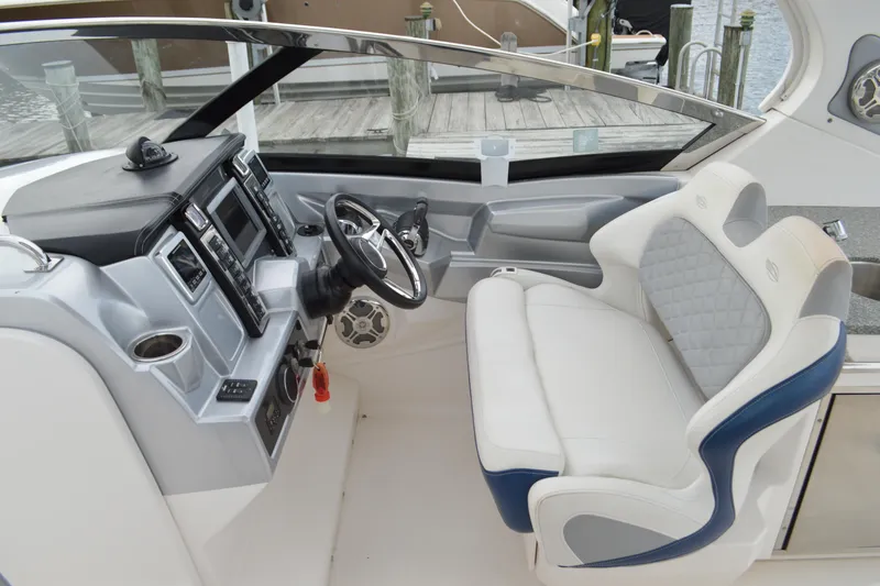 Slide: The Image of 2013 Chaparral 327 SSX boat cockpit with modern controls and comfortable seating. - 17