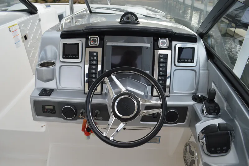 Slide: The Image of Cockpit of 2013 Chaparral 327 SSX boat with modern steering and control panel. - 18