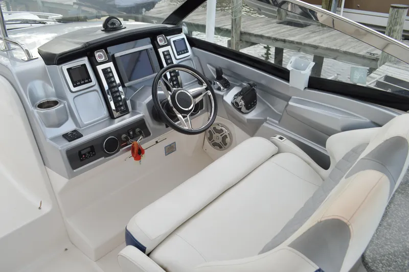 Slide: The Image of Cockpit of 2013 Chaparral 327 SSX boat with modern controls and steering wheel. - 19