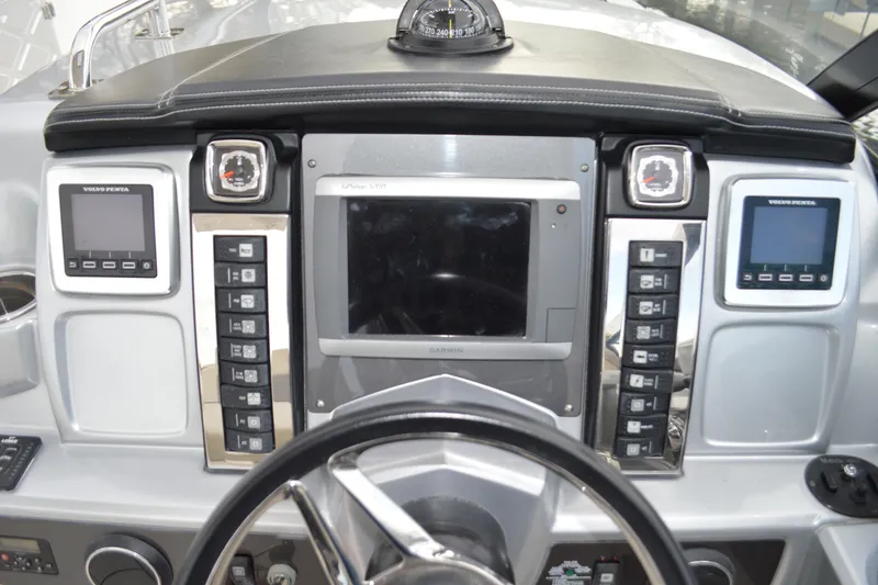 Slide: The Image of 2013 Chaparral 327 SSX dashboard with Garmin display and Volvo Penta controls. - 20