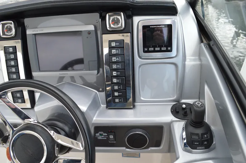 Slide: The Image of Control panel of 2013 Chaparral 327 SSX boat with Garmin and Volvo Penta displays. - 23