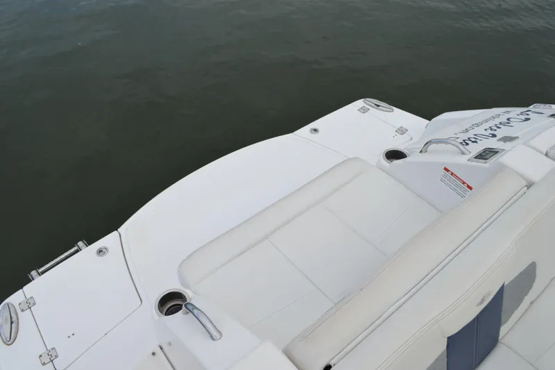 Slide: The Image of 2013 Chaparral 327 SSX boat with white seating and cup holders on the deck. - 28