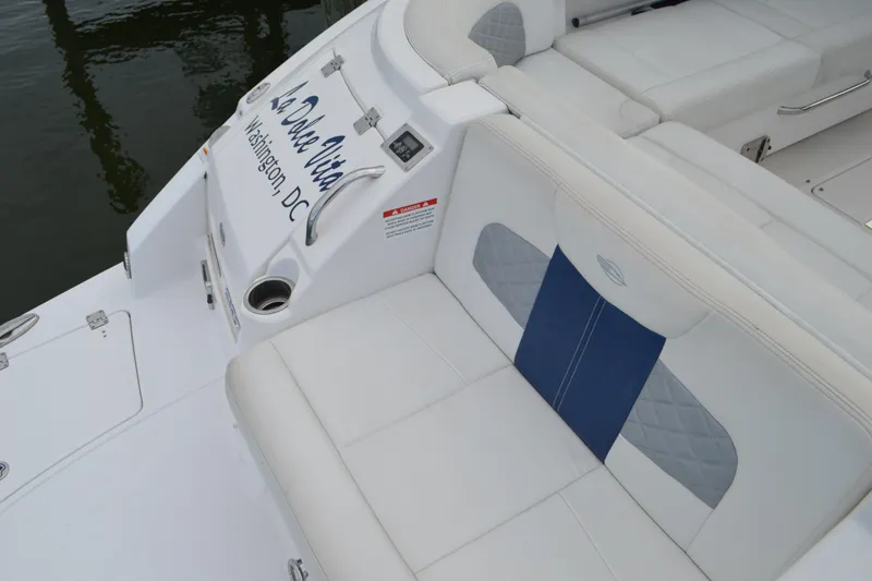 Slide: The Image of 2013 Chaparral 327 SSX boat with white and blue seating, docked in Washington, D.C. - 29