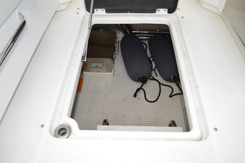 Slide: The Image of Storage compartment in 2013 Chaparral 327 SSX boat with fenders and equipment. - 31