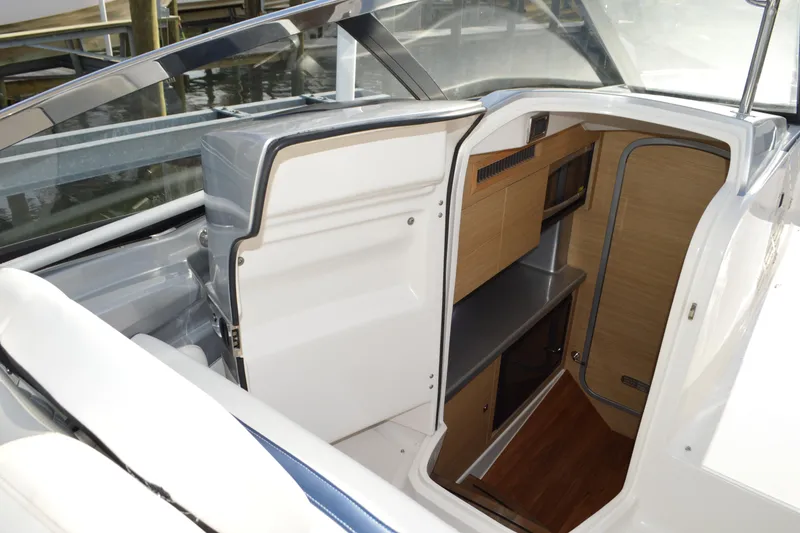 Slide: The Image of 2013 Chaparral 327 SSX boat interior with cabin entry and wooden finish. - 33