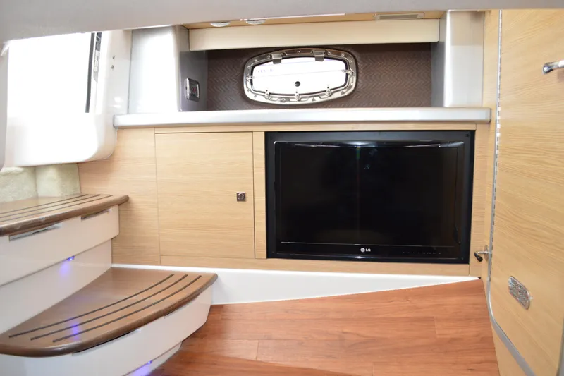 Slide: The Image of 2013 Chaparral 327 SSX interior with wooden steps and built-in LG TV. - 35