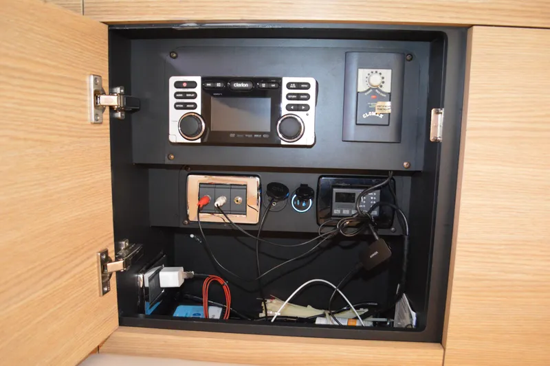 Slide: The Image of Control panel inside a 2013 Chaparral 327 SSX boat, featuring electronic equipment and wiring. - 39