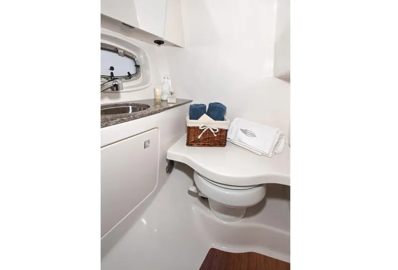 Slide: The Image of Manufacturer Provided Image: 2013 Chaparral 327 SSX boat bathroom with sink, toilet, and towels. - 40