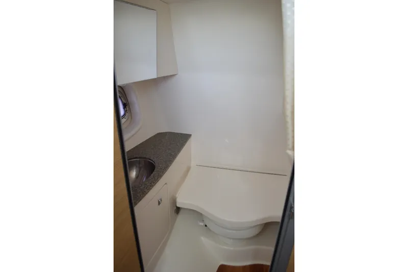 Slide: The Image of 2013 Chaparral 327 SSX boat bathroom with sink and compact toilet. - 41