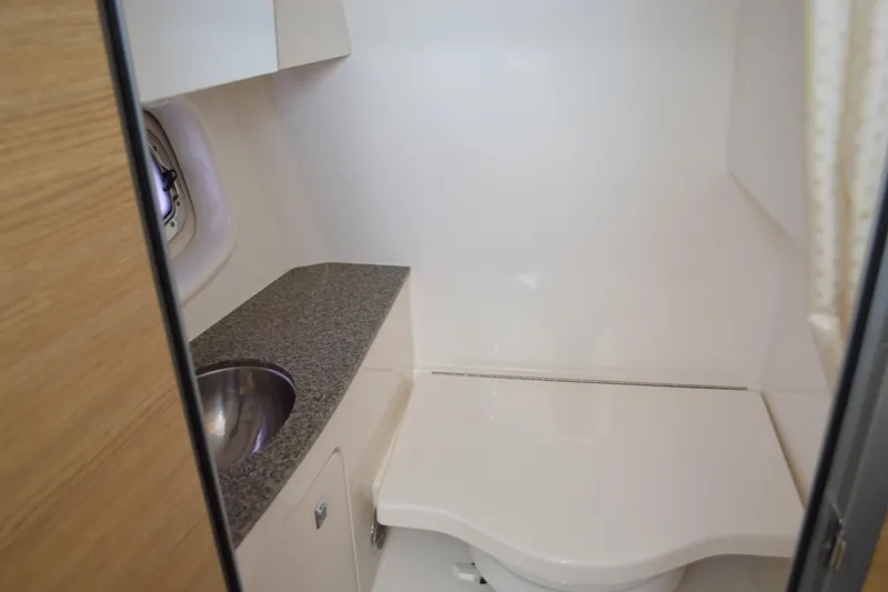 Slide: The Image of 2013 Chaparral 327 SSX boat bathroom with sink and toilet. - 42