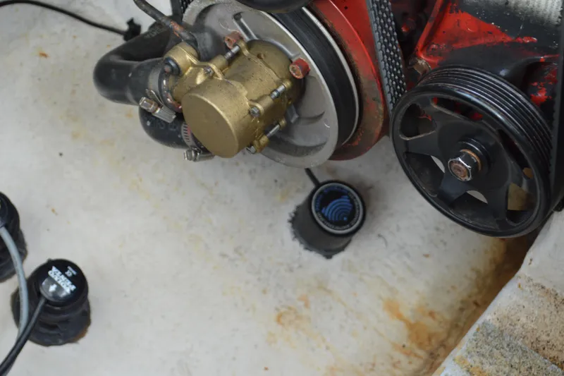 Slide: The Image of Engine components of a 2013 Chaparral 327 SSX boat, featuring pulleys and hoses. - 44