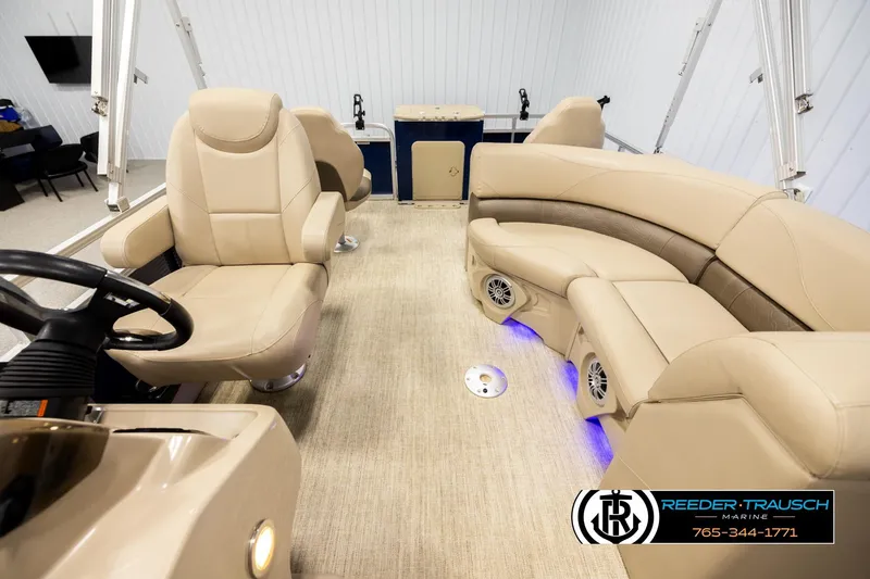 Slide: The Image of Luxurious interior of 2020 Avalon VEN FNC pontoon boat with beige seating and blue LED lights. - 14