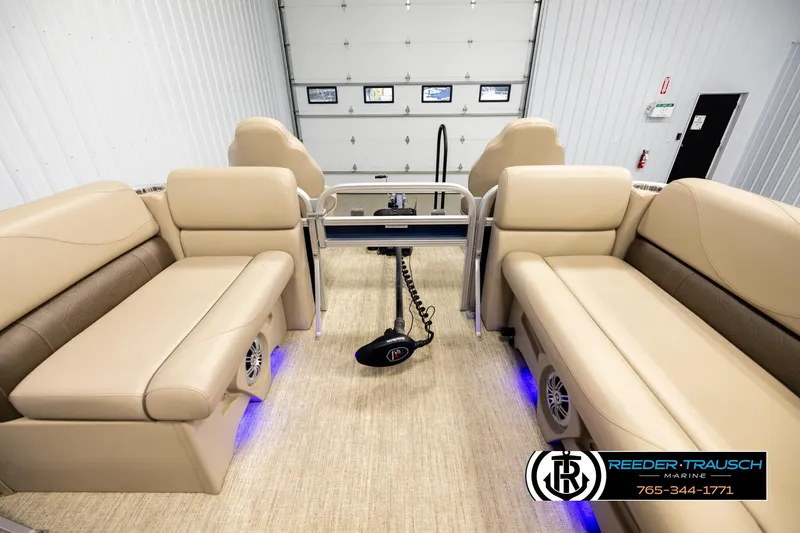 Slide: The Image of Interior of 2020 Avalon VEN FNC pontoon boat with beige seating and blue LED lighting. - 18