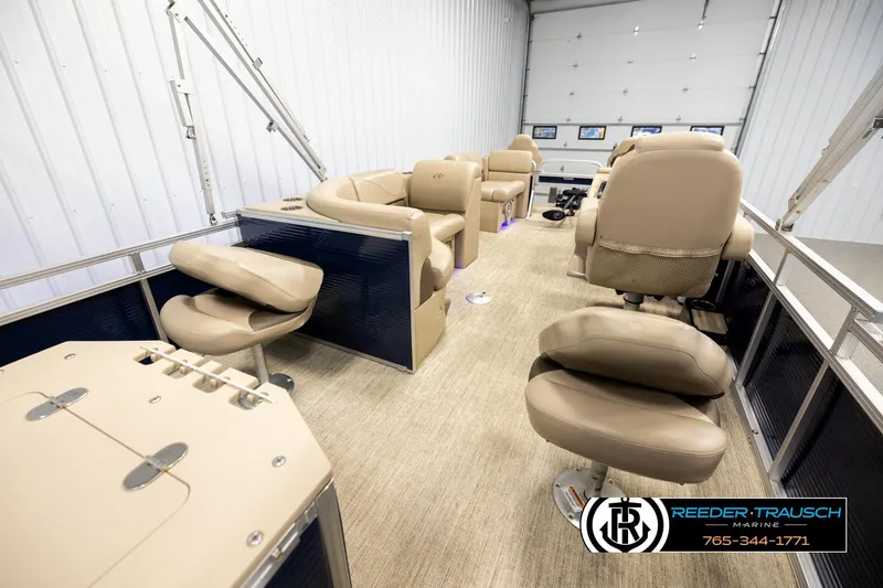 Slide: The Image of 2020 Avalon VEN FNC pontoon boat interior with beige seating, showcased by Reeder-Trausch Marine. - 25