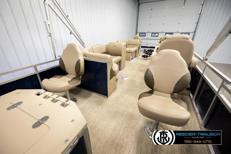Slide: The Image of 2020 Avalon VEN FNC pontoon boat interior with beige seating in a showroom. - 26