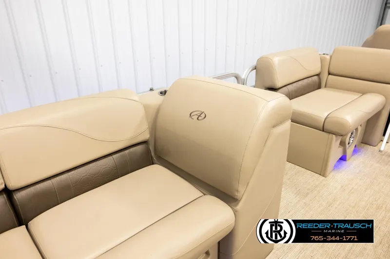 Slide: The Image of 2020 Avalon VEN FNC boat interior with beige seating and logo, Reeder-Trausch Marine branding. - 29