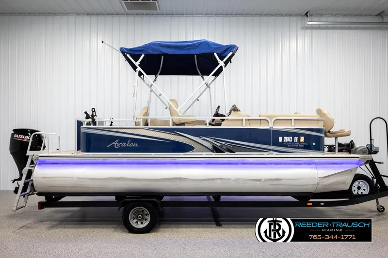 Slide: The Image of 2020 Avalon VEN FNC pontoon boat with blue canopy and Suzuki motor in showroom. - 5