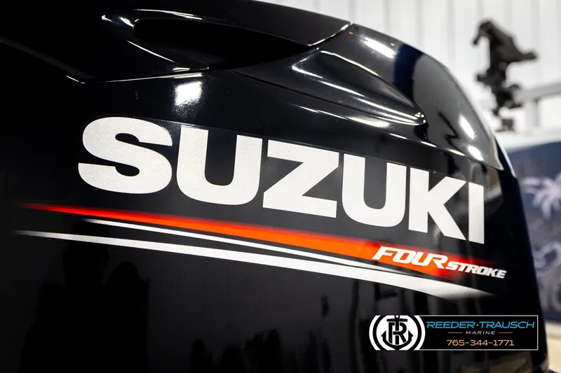 Slide: The Image of Suzuki Four Stroke engine close-up, featuring Reeder-Trausch Marine branding. - 54