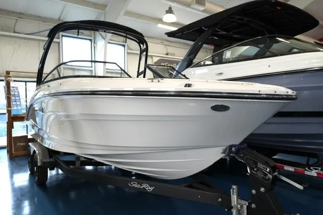 The Image of 2026 Sea Ray SPX 210 boat displayed indoors on a trailer. - 10