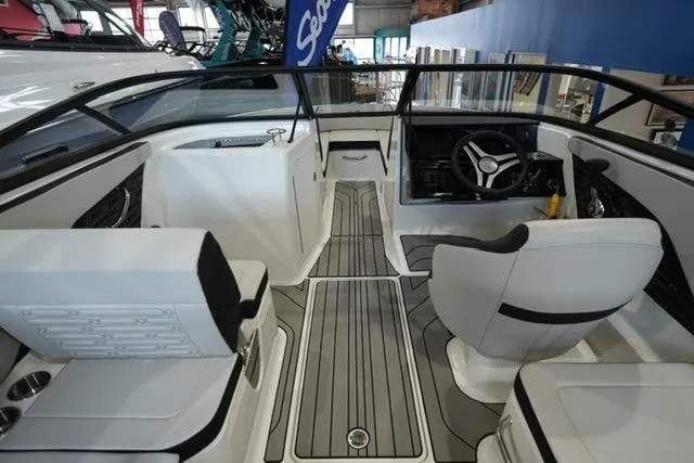 Slide: The Image of 2026 Sea Ray SPX 210 boat interior with sleek seating and modern dashboard design. - 15