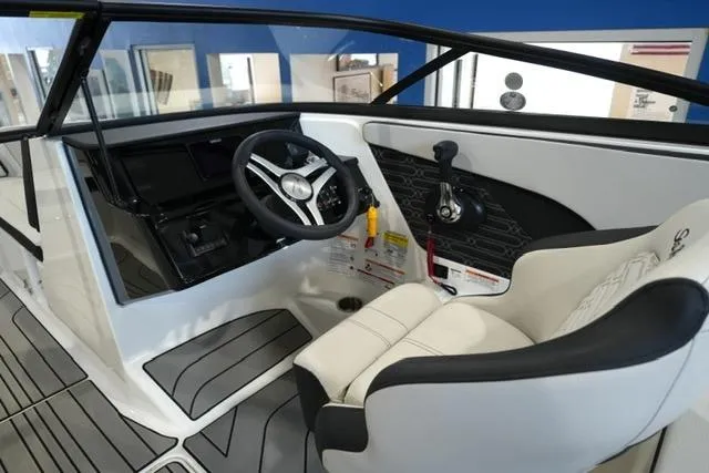 Slide: The Image of 2026 Sea Ray SPX 210 boat interior with steering wheel and control panel. - 16