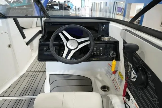 Slide: The Image of 2026 Sea Ray SPX 210 boat cockpit with steering wheel and control panel. - 17