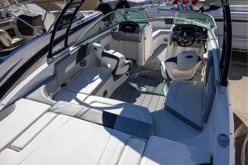 Slide: The Image of 2022 Chaparral 23 SSi OB boat interior with sleek seating and modern dashboard. - 4