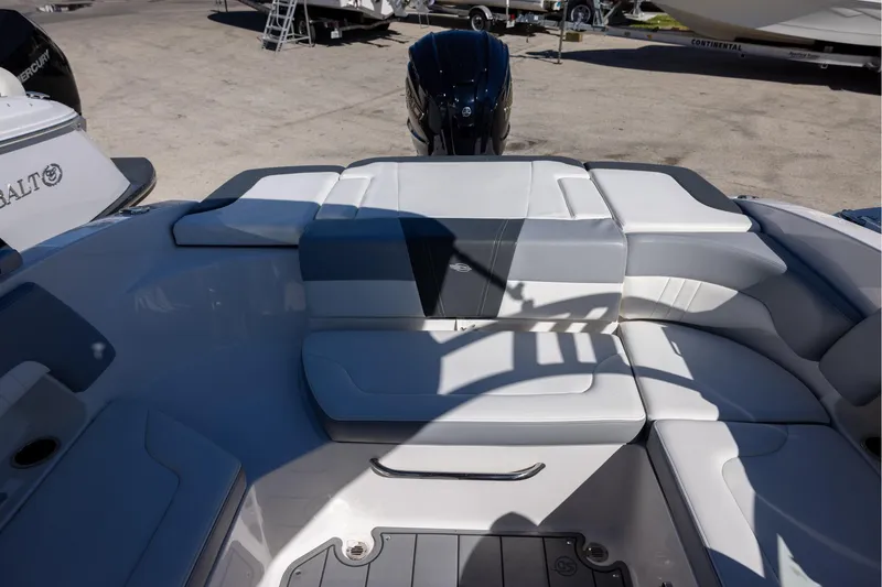 Slide: The Image of 2022 Chaparral 23 SSi OB boat interior with cushioned seating and outboard motor. - 5