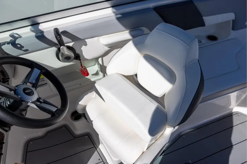 Slide: The Image of 2022 Chaparral 23 SSi OB boat interior with steering wheel and white captain's seat. - 6