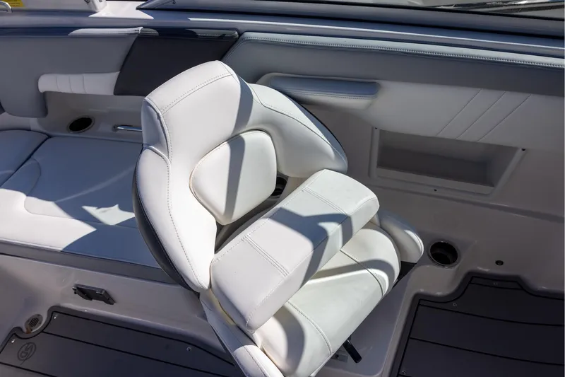 Slide: The Image of 2022 Chaparral 23 SSi OB boat interior with white cushioned seating. - 8