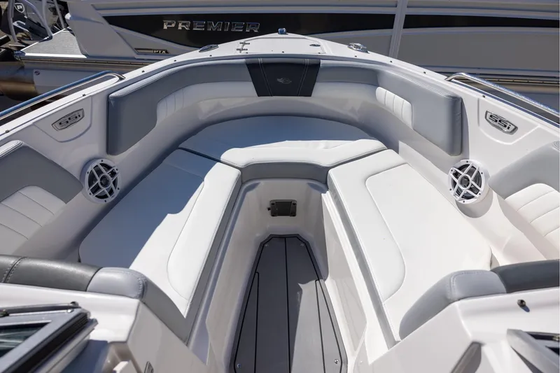 Slide: The Image of 2022 Chaparral 23 SSi OB boat interior with white seating and speakers. - 9
