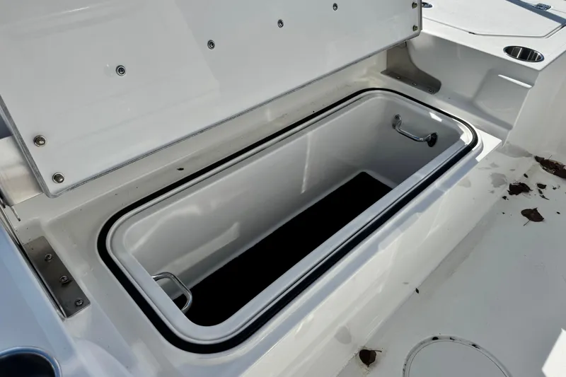 Slide: The Image of Open storage compartment on 2026 Caymas 28 HB boat deck. - 15