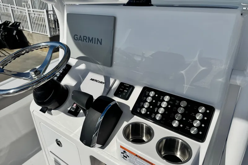 Slide: The Image of 2026 Caymas 28 HB boat dashboard with Garmin display and Mercury controls. - 18