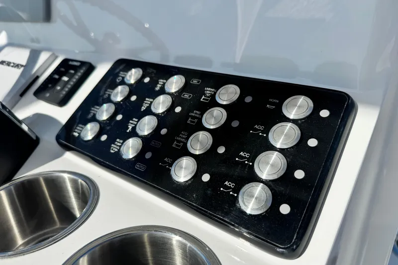 Slide: The Image of Control panel of 2026 Caymas 28 HB boat with buttons and cup holders. - 20