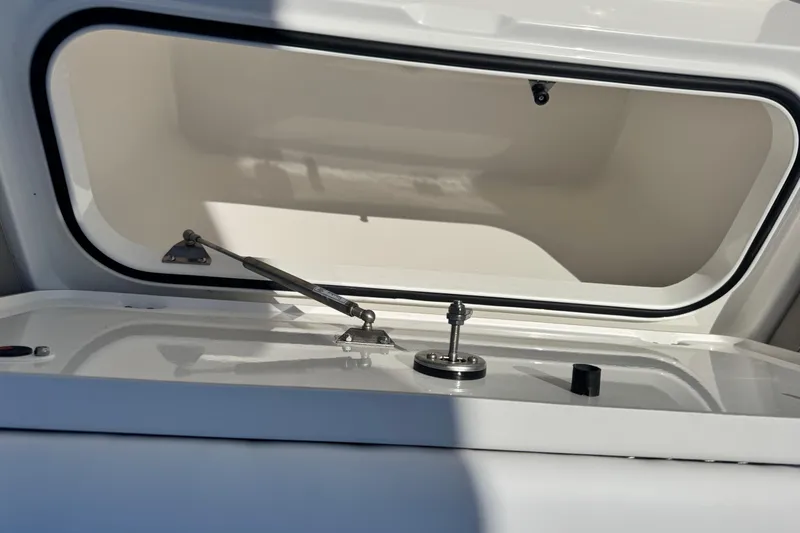 Slide: The Image of Open storage compartment on 2026 Caymas 28 HB boat, showcasing interior details. - 28